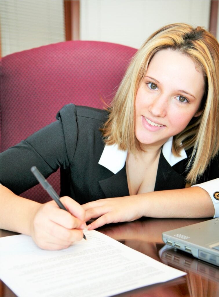 Student reviewing and signing her student accommodation contract