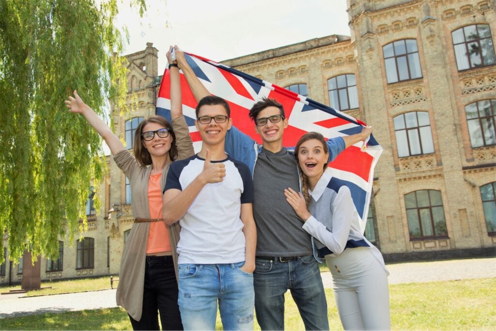 Four international students are happy to display the UK flag on the university campus where they study.